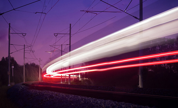 train lights speeding along train tracks at night